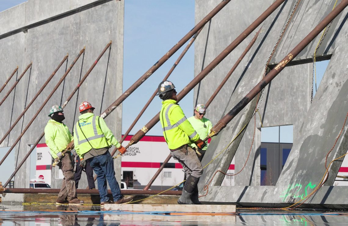 Adler Construction workers pulling up a wall.