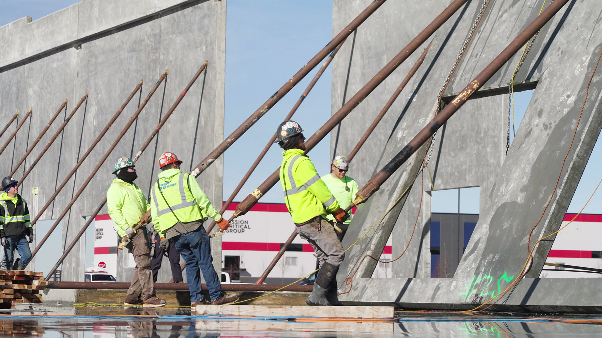 Adler Construction workers pulling up a wall.